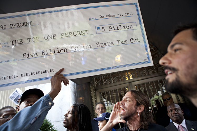 Occupy Wall Street protesters chant outside the Park Avenue home to billionaire David Koch and David Ganek, in New York, on Oct. 11, 2011. (AP/Andrew Burton)