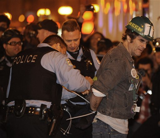 A protester gets arrested during an Occupy Chicago march and protest in Grant Park in Chicago, Sunday, Oct. 23, 2011 (AP Photo/Paul Beaty)