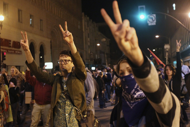 A group of "Occupy Wall Street" demonstrators flashing peace signs in Oakland (Stephen Lam / Reuters)