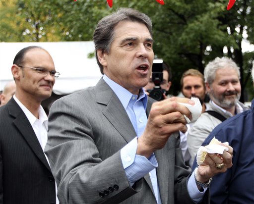Republican presidential candidate, Texas Gov. Rick Perry reacts after taking a bite of chili during a campaign stop a the Chili Festival Saturday, Oct. 1, 2011, in Manchester, N.H. (AP Photo/Jim Cole) (AP)
