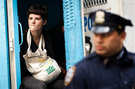 An Occupy Wall Street protester is arrested for allegedly trespassing on Citibank property near Washington Square Park, Saturday, Oct. 15, 2011, in New York (AP Photo/John Minchillo)