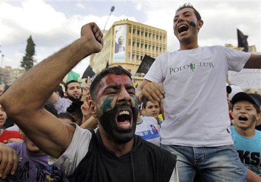 Anti-regime protesters shout slogans against Syrian President Bashar Assad, during a protest after Friday prayers in the northern city of Tripoli, Lebanon, on Friday Oct, 7, 2011 in a show of support for Syrians protesting against Syrian President Bashar Assad. () (AP/Bilal Hussein)