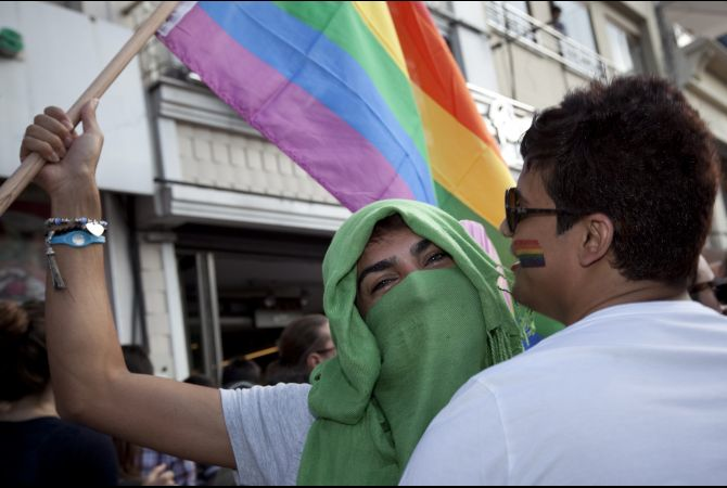 Holding a rainbow flag and dressed in hijab, an LGBT supporter makes a political statement at the Gay Pride March in Istanbul on June 19, 2011 (Jodi Hilton/GlobalPost)