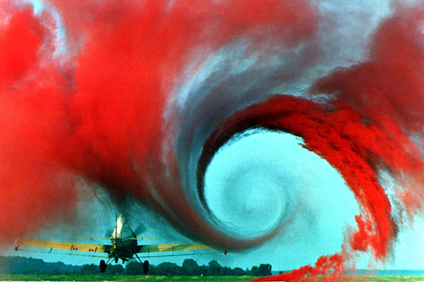 The air flow from the wing of this agricultural plane is made visible by a technique that uses colored smoke rising from the ground. (Wikipedia/NASA)