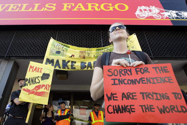 Occupy Oakland protesters stand outside of a Wells Fargo bank in Oakland, Calif., Weds., Nov. 2, 2011. (AP/Paul Sakuma)
