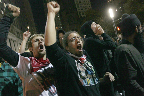Occupy Wall Street demonstrators chant slogans at a police barricade near t Zuccotti Park early Tuesday (AP/Mary Altaffer)