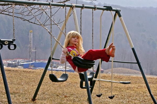 Rachel Farnelli rides on her backyard swing that overlooks the Gesford #3 natural gas well in Dimock, Pennsylvania, in this March 7, 2009 file photo. (Tim Shaffer / Reuters)