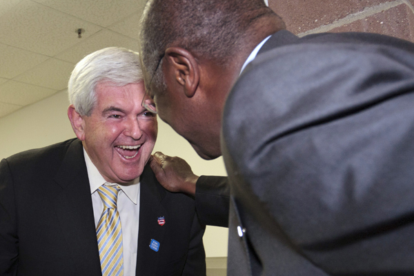 Newt Gingrich (left), former speaker of the House, laughs with Herman Cain. (Brian Frank / Reuters)