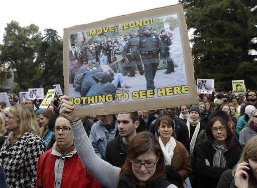 A student holds a sign during a rally on the University of California, Davis campus in Davis, Calif., Monday, Nov. 21, 2011 after police pepper-sprayed peaceful demonstrators during a protest at the same spot on Friday (AP Photo/Paul Sakuma)