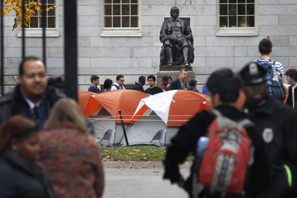 Occupy Harvard, near a statue of the university's founder, John Harvard. (AP/Steven Senne)