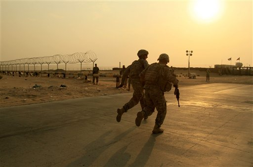 U.S. Army soldiers race toward the border from Iraq into Kuwait on Wednesday, Aug. 18, 2010. (AP/Maya Alleruzzo, File)