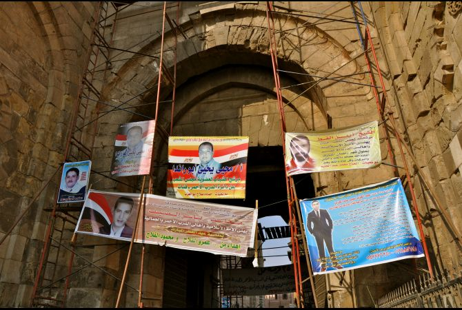 Advertisements for parliamentary candidates hang from scaffolding in Cairo in October 2011 (Lauren E. Bohn/GlobalPost)
