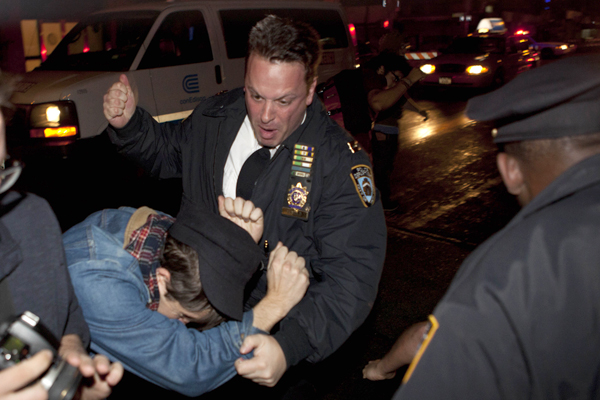An Occupy Wall Street protester draws contact from a police officer near Zuccotti Park after being ordered to leave the longtime encampment in New York, Nov. 15, 2011 (AP/John Minchillo)