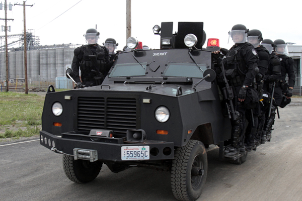 Police in riot gear move to a location at the port facilities in Longview, Wash., Wednesday, Sept. 21, 2011. (AP/Don Ryan)