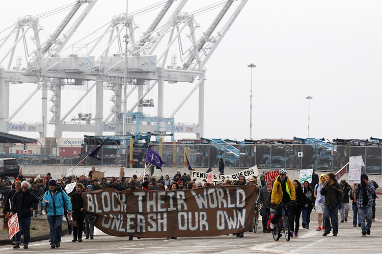 Protestors leave the Port of Oakland after successfully blocking the entrances on December 12. (AP/Beck Diefenbach)