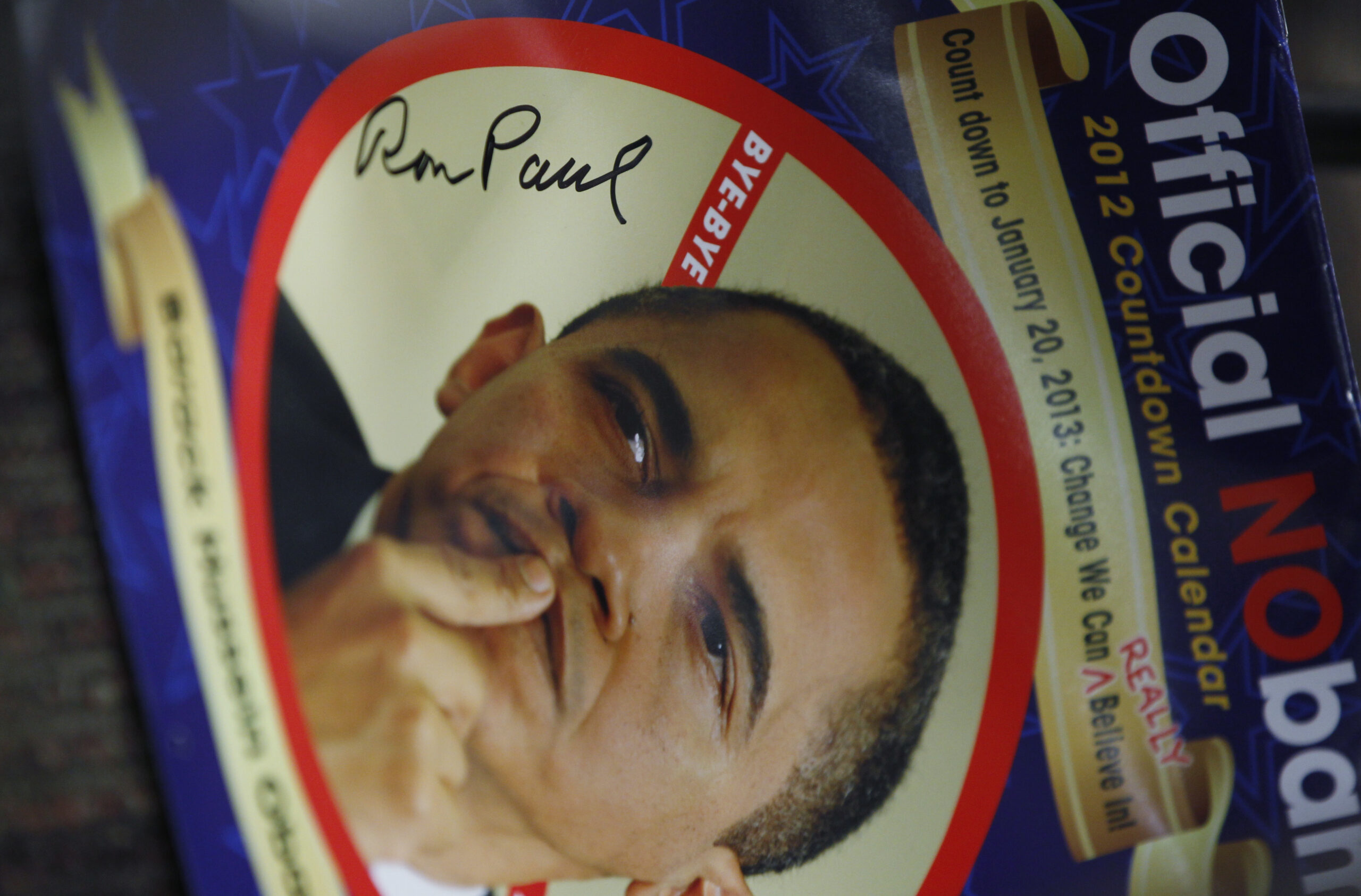 The signature of Rep. Ron Paul, R-Texas, is shown on the cover of an "Obama Countdown Calendar" during a campaign stop in Atlantic, Iowa, Thursday. (AP Photo/Charles Dharapak)