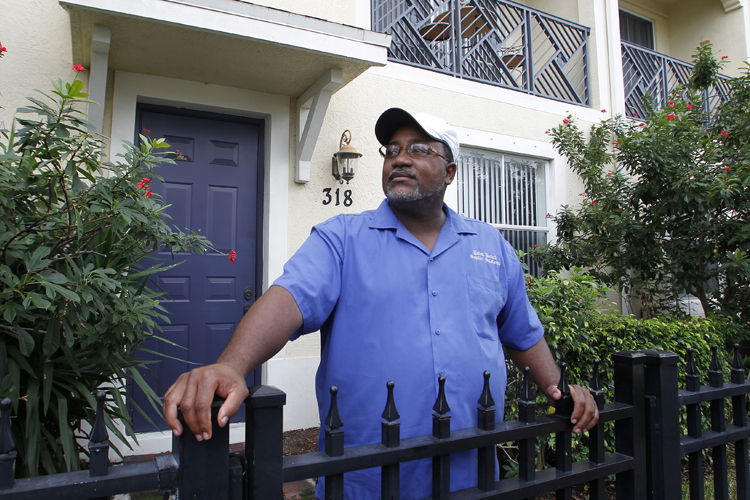 Curtis Jones stands in front of his two-story townhouse in Delray Beach, Fla., in October 2010. Seven years ago, Jones took out a mortgage with Countrywide Financial Corp to buy his home. The company has now launched foreclosure proceedings against him. Jones has fought for more than a year to keep his home from being foreclosed. (Joe Skipper / Reuters)