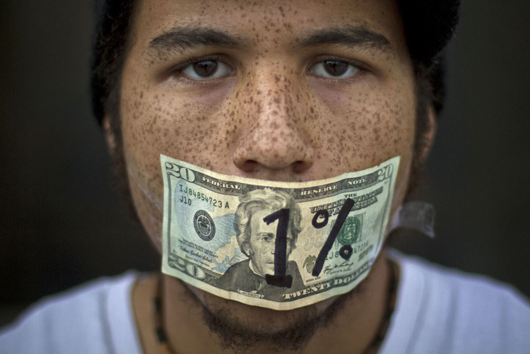Roshan Bliss, who says he has a debt of $50,000 in school loans, attends an Occupy Denver demonstration in Denver, Colorado (Nathan Armes / Reuters)