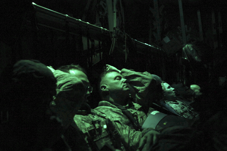 Members of the U.S. military rest on board an Air Force C-130 transport plane marking the end of their presence in Iraq after departing the Baghdad Diplomatic Support Center in Baghdad December 15, 2011. (Shannon Stapleton / Reuters)