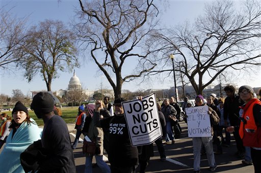 Demonstrators chant for jobs outside on Capitol Hill in Washington, Thursday Dec. 8, 2011. Dozens of activists protesting the U.S. government's failure to help the unemployed are marching to the Capitol to pray for and shout at members of Congress _ above all, the leader of the House, Speaker John Boehner. (AP Photo/Jose Luis Magana) (AP)