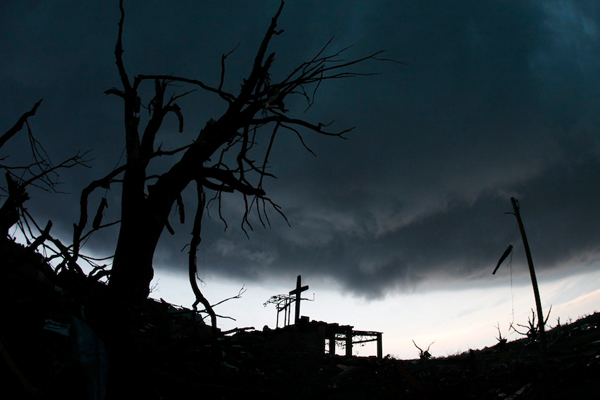A cross stands atop a severely damaged church in Joplin, Mo. (AP/Charlie Riedel)