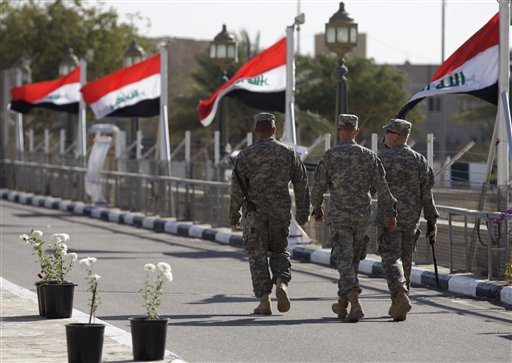 Iraqi flags wave as U.S. soldiers leave Al Faw palace at Camp Victory on Thursday, Dec. 1, 2011 (AP Photo/Khalid Mohammed)