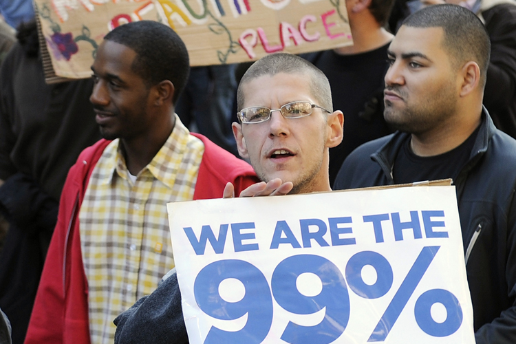 Occupy DC protesters hold signs during a march (Jonathan Ernst / Reuters)