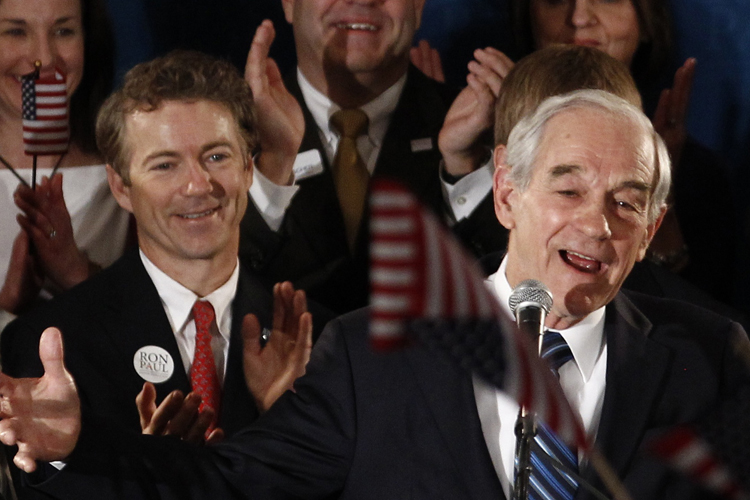 Republican presidential candidate Congressman Ron Paul speaks to supporters as his son Senator Rand Paul (L) applauds at his Iowa Caucus night rally in Ankeny, Iowa, January 3, 2012 (Jim Young / Reuters)