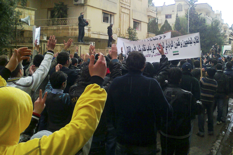 Demonstrators protest against Syria's President Bashar al-Assad in Homs (Reuters)