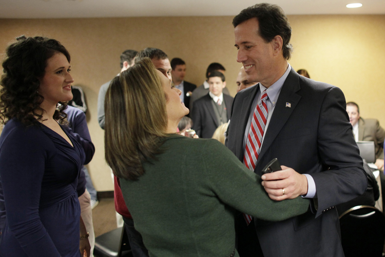 Republican presidential candidate and former U.S. Senator Rick Santorum with his wife Karen Garver Santorum (C) and daughter Elizabeth as he reacts to Iowa Caucus voting results at a caucus rally in Johnston, Iowa, January 3, 2012. (John Gress / Reuters)