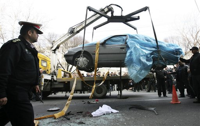 In this photo provided by the semi-official Fars News Agency, people gather around a bombed car in Tehran, Iran, Wednesday, Jan. 11, 2012 (AP Photo/Fars News Agency, Mehdi Marizad)