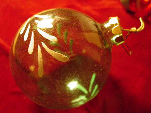 Hand-painted glass ornament produced in the 1940s during WWII. The cardboard cap replaced the traditional metal cap and hook due to material shortages during the war. (Helen West)