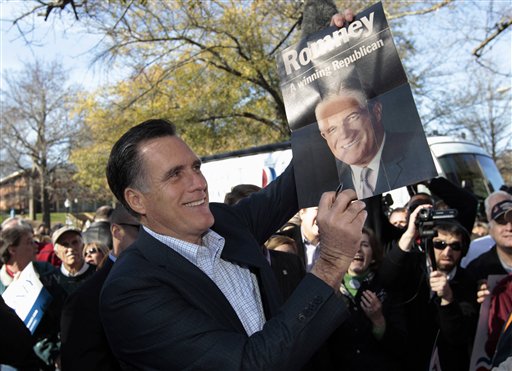 Mitt Romney holds up a poster of his father George Romney, Spartanburg, S.C., Jan. 18, 2012. (AP Photo/Charles Dharapak) (AP)