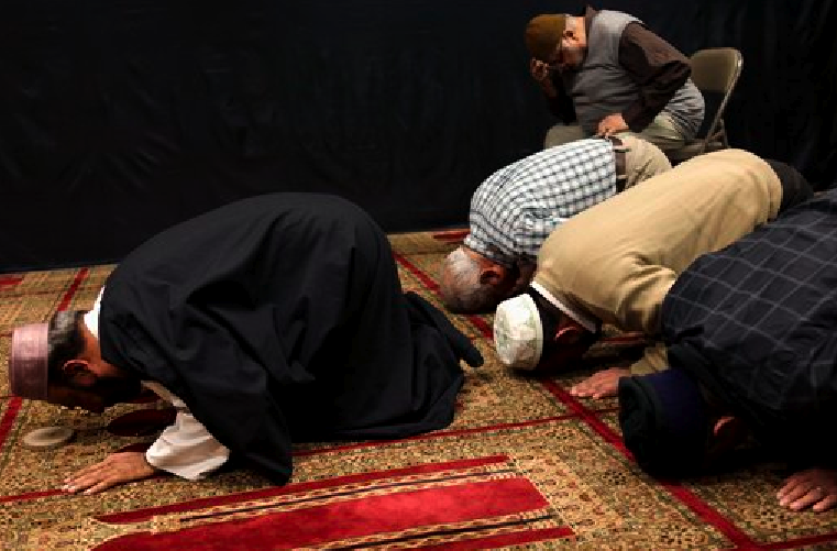 Imam Malik Sakhawat Hussain, left, leads prayers at the Al-Mahdi Foundation in New York, Wednesday, Feb. 1, 2012. The New York Police Department recommended increasing surveillance of thousands of Shiite Muslims and their mosques based solely on their religion, (AP Photo/Seth Wenig)