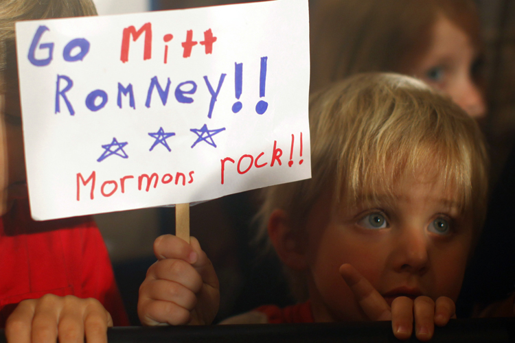 Three-year-old Dean Call holds a sign as Mitt Romney speaks during a campaign rally in Columbia, S.C., on Jan. 11, 2012. (Brian Snyder / Reuters)