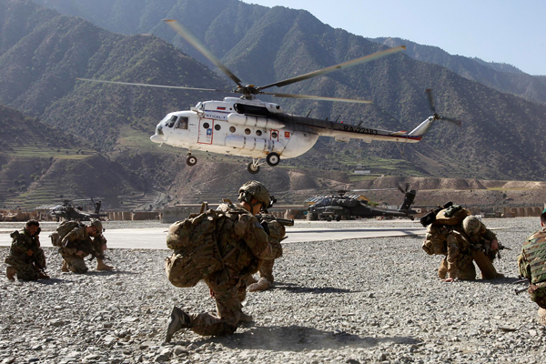 A helicopter lands near U.S. soldiers at the Forward Operating Base Bostic  in Kunar, Afghanistan (Reuters/Erik de Castro)