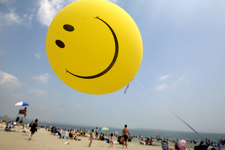 A smiley-face balloon floats over Revere Beach in Revere, Mass. (AP)