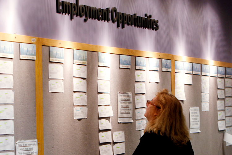 Lori Kamlet looks at posted employment opportunities at a Denver employment office. (AP)