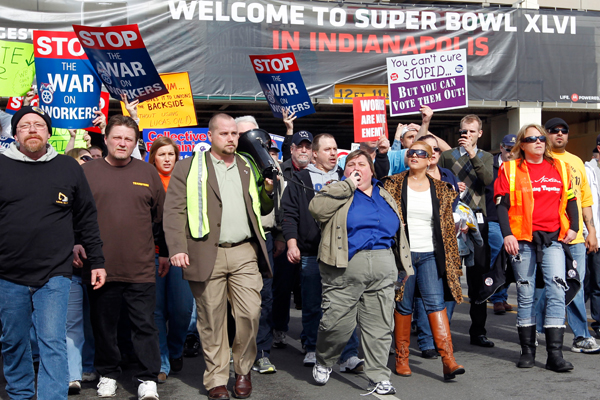 Muted union protestors in the Super Bowl Village on Sunday. (AP/Michael Conroy)