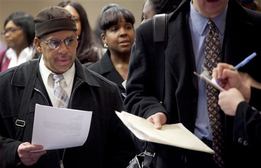 In this Dec. 12, 2011 file photo, people wait to talk with potential employers at a job fair sponsored by National Career Fairs, in New York (AP Photo/Mark Lennihan)