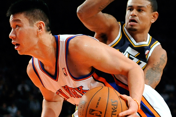 Jeremy Lin drives the ball past Earl Watson during the second half of Monday nights game. (AP/Kathy Kmonicek)