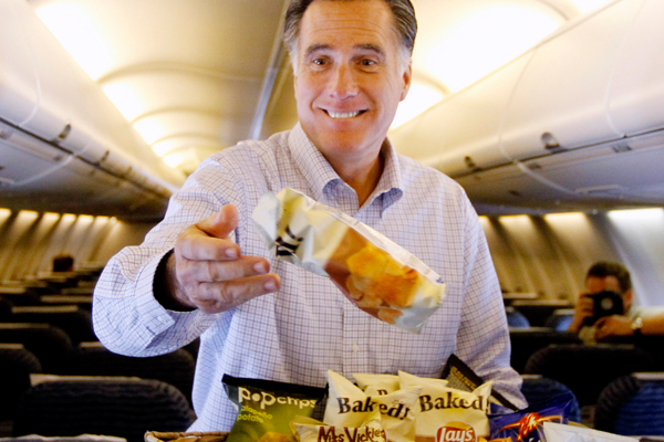 Mitt Romney throws bags of chips at traveling reporters on his campaign charter plane. (AP/Charles Dharapak)