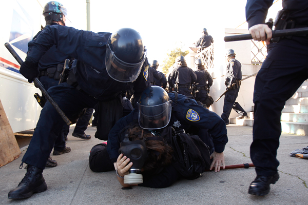 Members of the Oakland Police Department arrest an Occupy Oakland demonstrator in Downtown Oakland, California January 28, 2012 (Reuters/Stephen Lam)