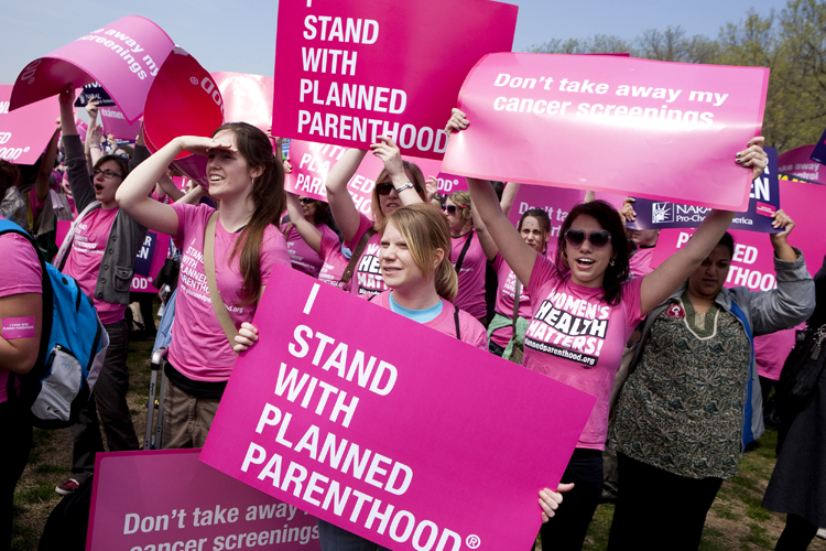 Members of Planned Parenthood, NARAL Pro-Choice America and more than 20 other organizations hold a "Stand Up for Women's Health" rally in supporting preventive health care and family planning services, including abortion in Washington April 7, 2011. (Reuters/Joshua Roberts)
