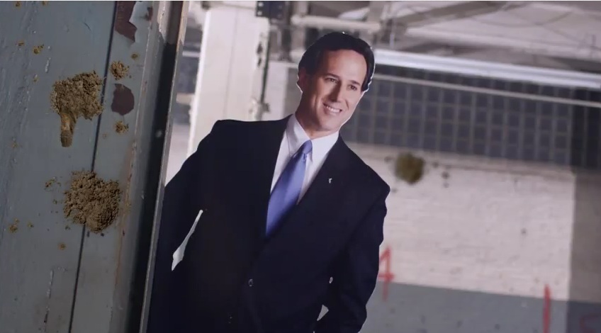 A Rick Santorum cut-out, with "mud" (Rick Santorum/YouTube)
