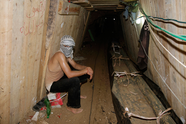 A Palestinian sits in a smuggling tunnel beneath the Egyptian-Gaza border in Rafah. (Reuters//Ibraheem Abu Mustafa)