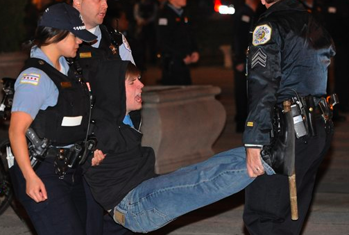 In this Oct. 23, 2011 file photo, a protester gets arrested during an Occupy Chicago march and protest in Grant Park in Chicago. (AP Photo/Paul Beaty,File)