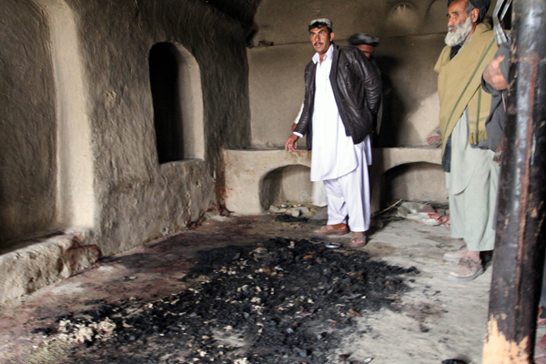 Blood stains and charred remains are all that remains inside a Kandahar home where witnesses say a family of Afghans was slain by a U.S. soldier. (AP/Allauddin Khan)