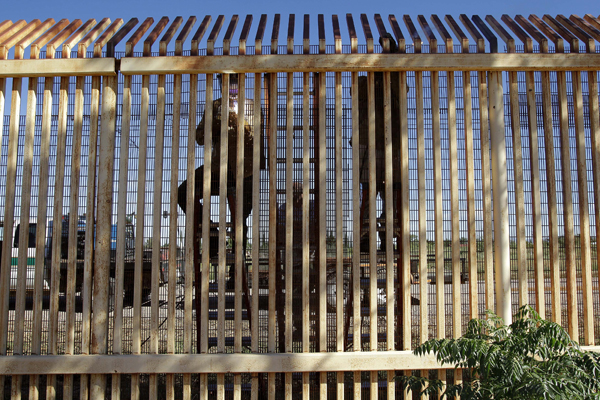 In this Sept. 27, 2010 photo, contractors reinforce a section of damaged border fence as seen from Sonora, Mexico (AP/Matt York)