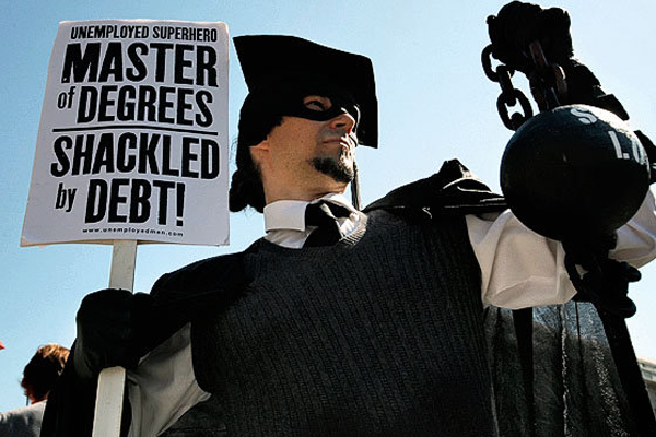 A protester holds a ball and chain representing his college loan debt during an Occupy DC protest in Washington. (AP/Jacquelyn Martin)